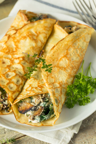 istock Savory Homemade Mushroom and Spinach Crepes 873075898