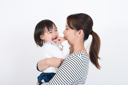 family image on white background, without heavy processing but carefully and naturally retouched on skin clothing items and so on, very clean and neat image overall, photographed in ISO 100