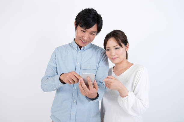 istock couple watching cell phone with smile 873081036