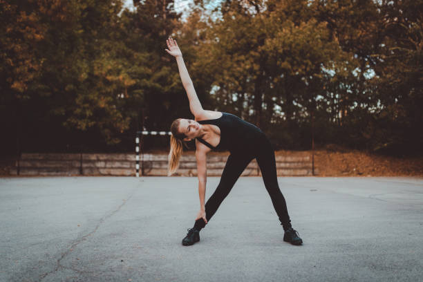 istock Strong young woman doing exercise outdoors 873082424