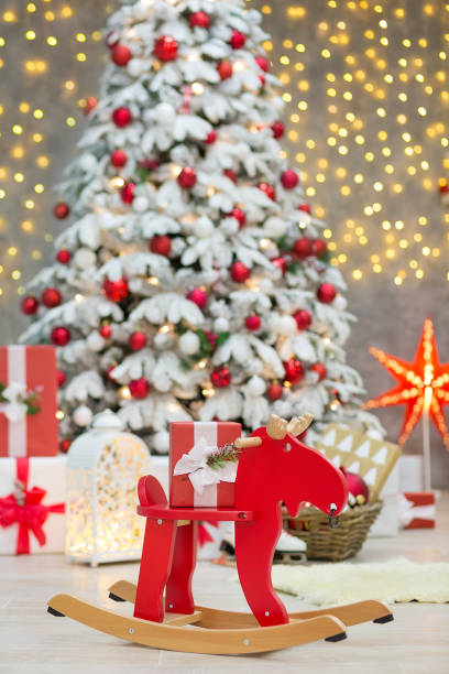 istock Christmas studio decorations wonderful idea mainly white and red New Year tree with snow and plenty presents under Amazing LED lights bake and huge paper star. 873088090