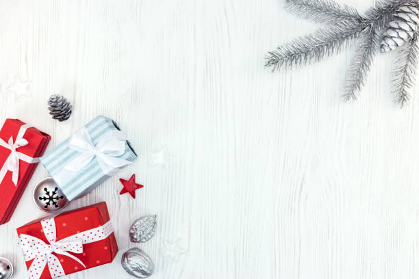 istock christmas wooden background with fir tree branch and gift boxes 873097902