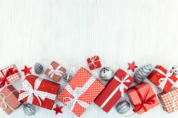 istock gift boxes wrapped in red paper, christmas decorations on white wooden table 873101268