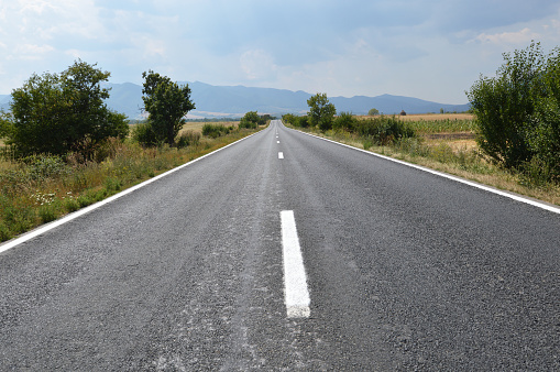Panoramic view of empty road with mountains on the background