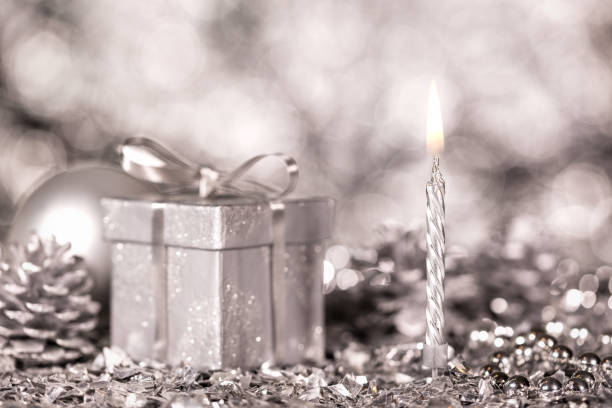istock silver christmas decoration with one candle and shiny sparkles 873117696