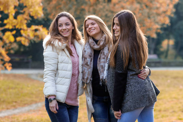 istock Three beautiful girls in park 873117806