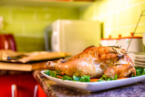 istock Closeup view of roasted chicken on white plate on kitchen table 873122824