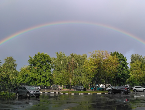 puddles and total rainbow over the car parking