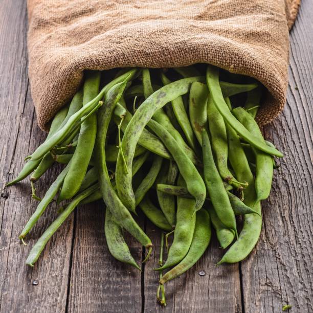 istock Green beans pods on a wooden table 873131068