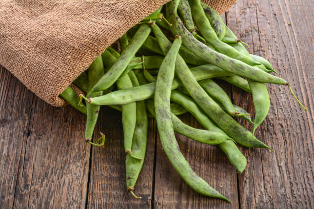 istock Green beans pods on a wooden table 873134014