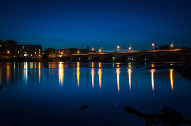 night city with reflection of houses in the river close up