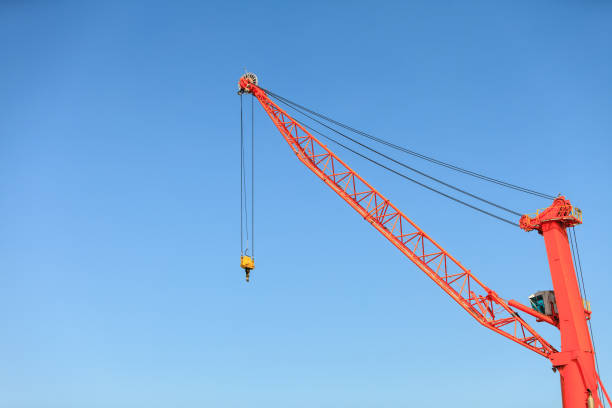 Commerce transport industry cargo machine technology concept. Lonely crane in port. Industrial device in maritime facility.