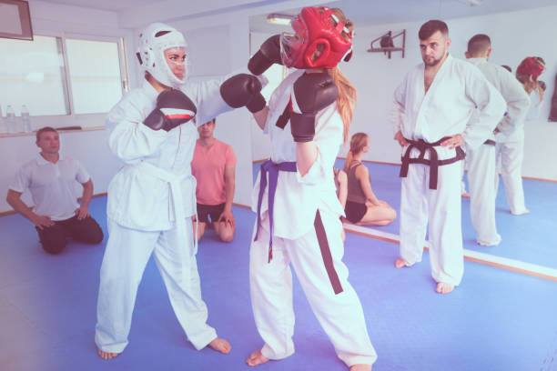 istock Females are sparring in pair to use taekwondo technique 873173402