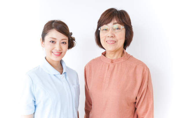 istock elderly woman and nurse 873176064