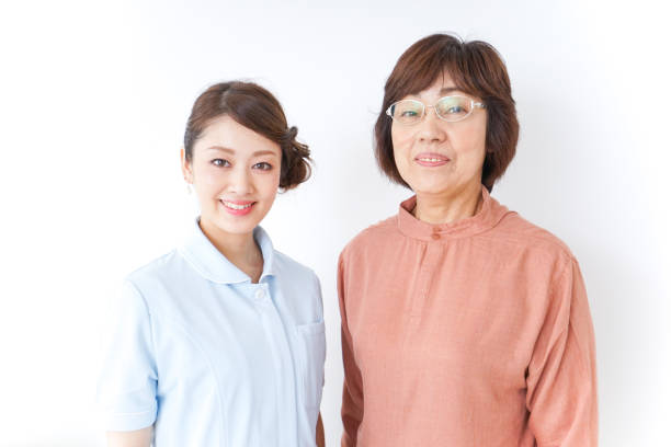 istock elderly woman and nurse 873176068