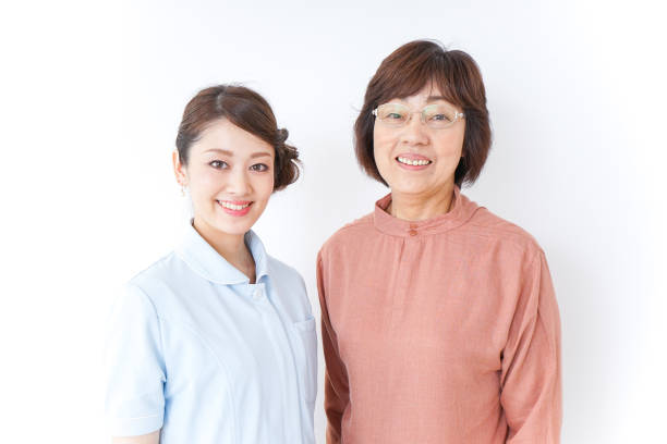 istock elderly woman and nurse 873176092