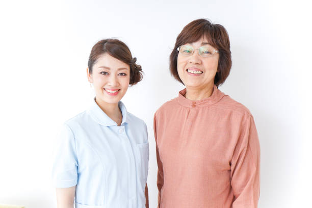 istock elderly woman and nurse 873176094
