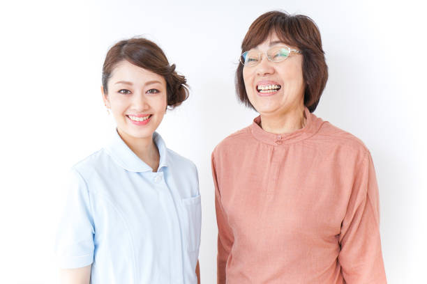 istock elderly woman and nurse 873176100
