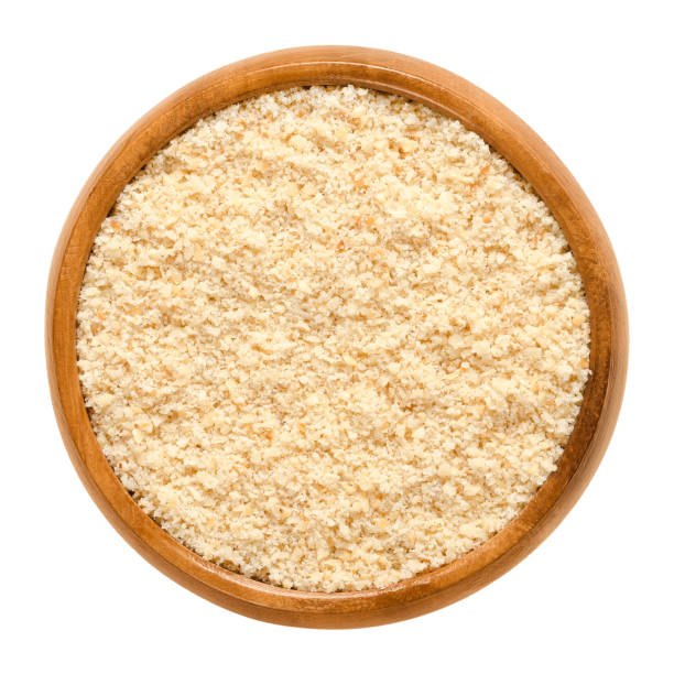 istock Ground hazelnuts in wooden bowl over white 873177186