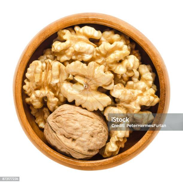 Walnut And Shelled Walnut Kernel Halves In Wooden Bowl Stock Photo - Download Image Now