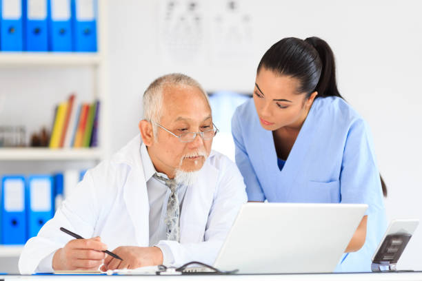 istock Nurse and doctor using laptop in cabinet 873177468