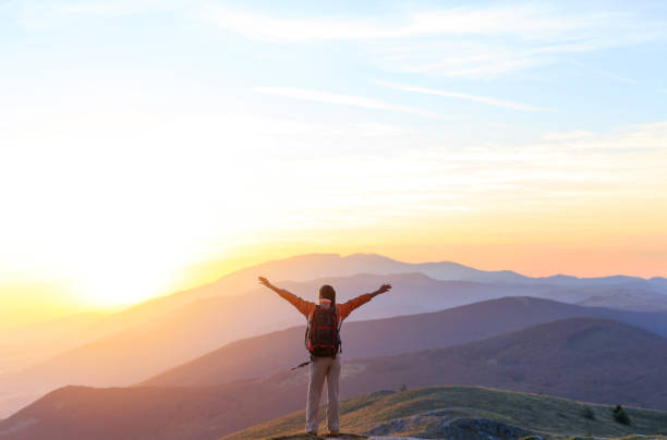 istock Cheerful woman on top mountain 873178878