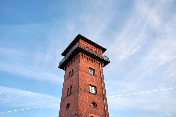 istock Old Brick Tower at Sunset, under a cloudy blue sky 873180070
