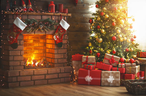interior christmas. magic glowing tree, fireplace, gifts - fire place imagens e fotografias de stock