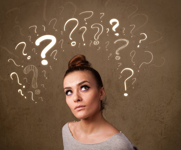 istock girl with question mark symbols around her head 873181746