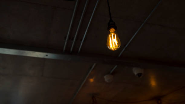 istock Tungsten Light Bulb Lighting in Dark Modern Room 873192478