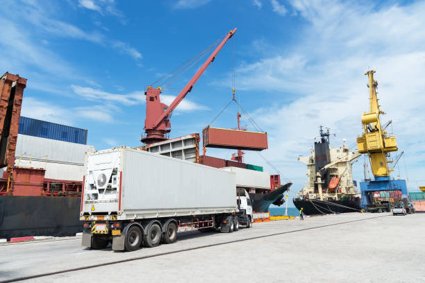 istock container,container ship in import export and business logistic.By crane , Trade Port , Shipping.Tugboat assisting cargo to harbor. 873192922
