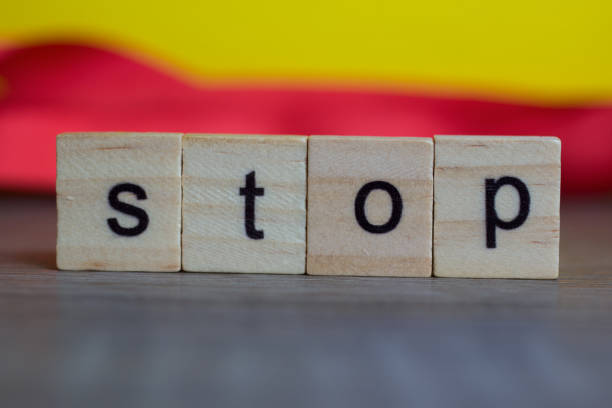 istock Stop word on wood cubes on table against colorful background 873197442