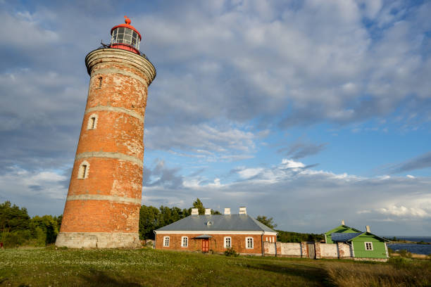 istock Lighthouse and house in the Baltic Sea. Shore, evening light, sunset, clouds and architecture concept. Mohni, small island in Estonia, Europe. 873197864