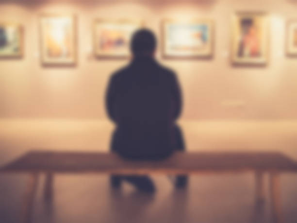 Man in exhibition's gallery backgrounds.