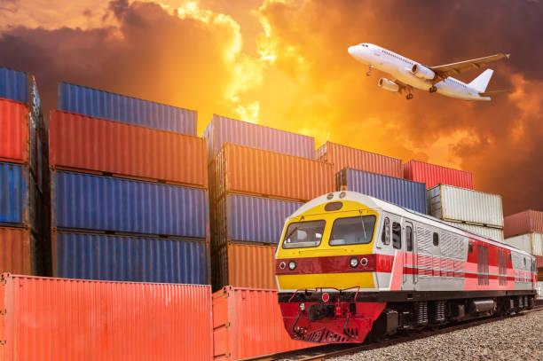 istock Global business with commercial cargo freight train and container cargo stack at the dock during cargo plane flying above on sunset time. 873203912