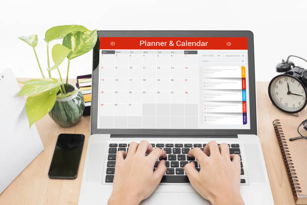 istock business hand typing on a laptop keyboard with Calender Planner homepage on the computer screen. organization management remind concept. 873204614