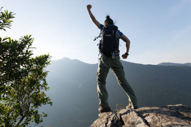 istock successful young woman enjoy the view on cliff's edge 873208854