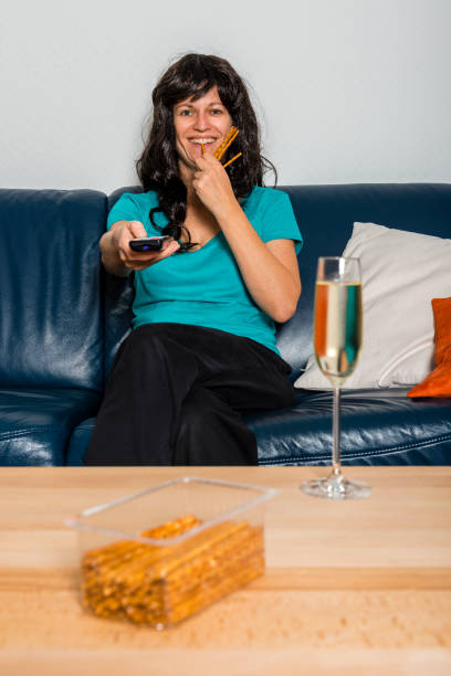 istock woman with television remote control 873209284