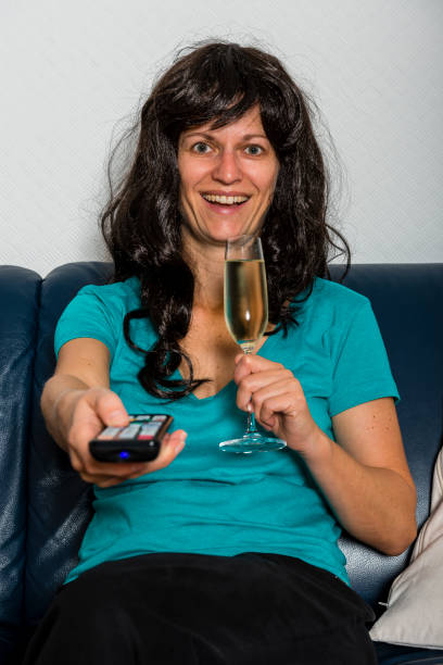 istock woman with television remote control 873209320