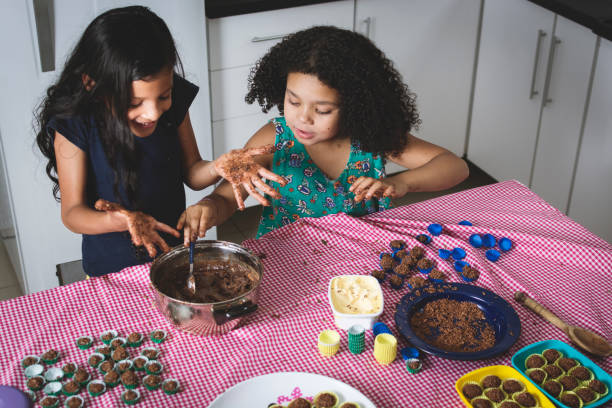istock Girls making chocolate truffle 873209334