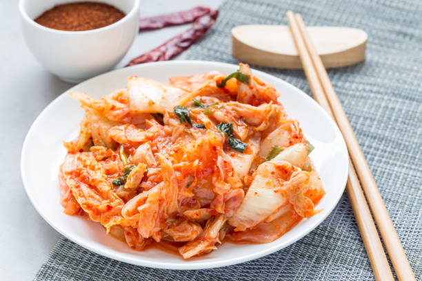 istock Kimchi cabbage. Korean appetizer on white plate, horizontal 873212266