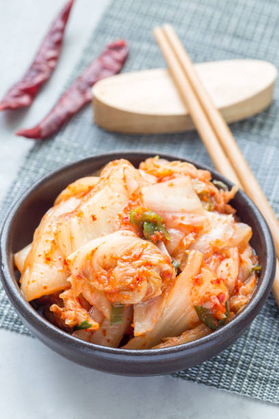 istock Kimchi cabbage. Korean appetizer in ceramic bowl, vertical 873212278