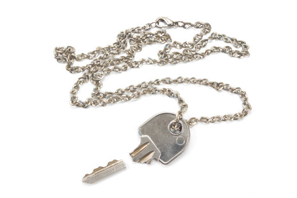istock Broken house key on chain isolated on white background 873216352