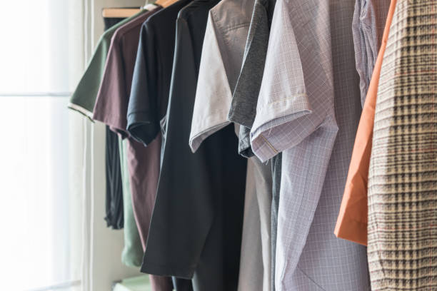 istock wooden wardrobe with clothes hanging on rail 873220440