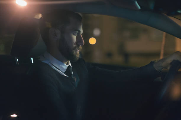 istock Businessman driving car at night 873223188