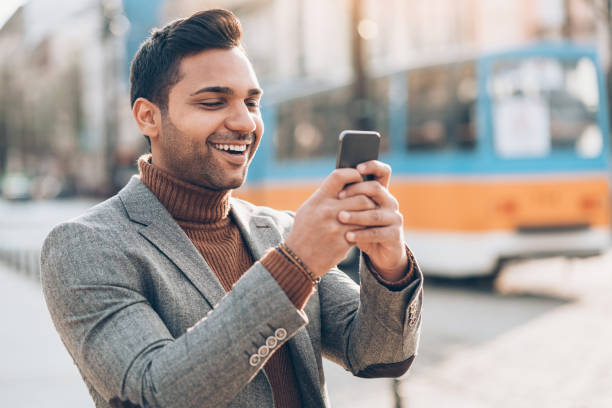 istock Cheerful young man with smart phone 873226350