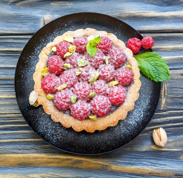 istock Tartlet with chocolate and fresh raspberries. 873226850