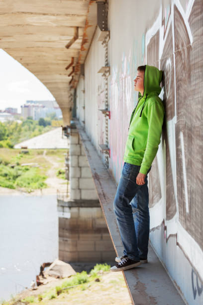istock Sad young man in depression standing on the bridge 873231542