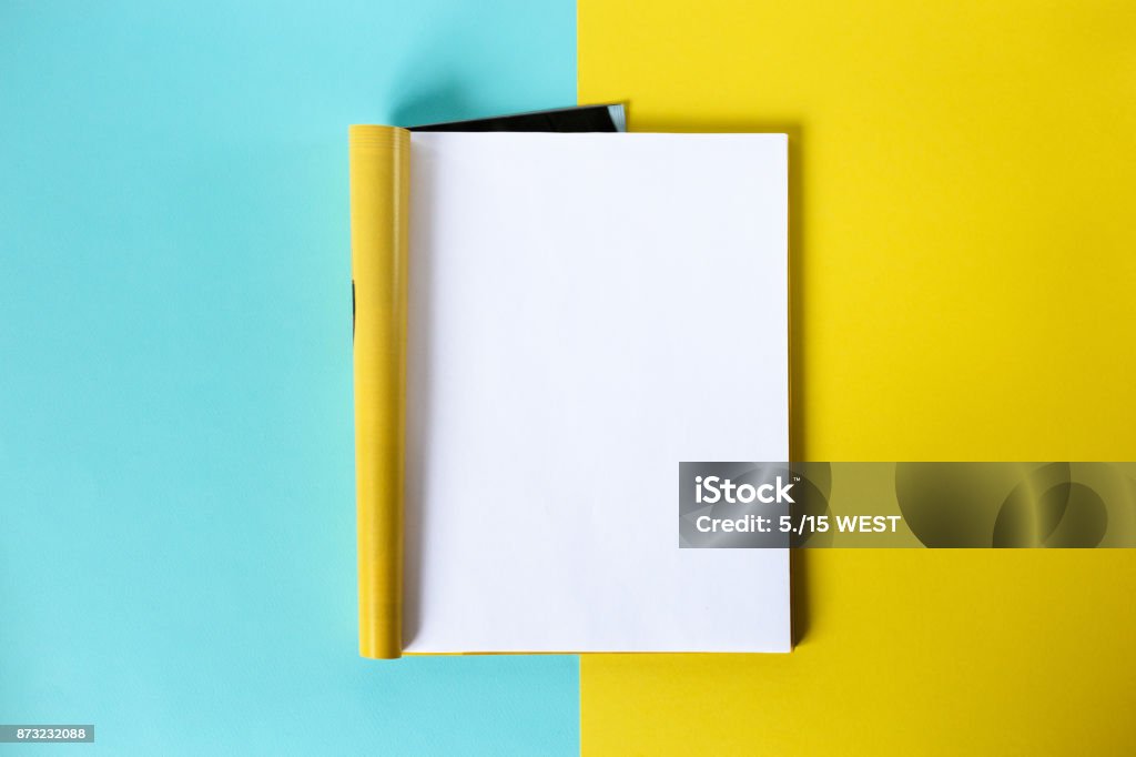 Mock-up magazine and catalog concept. Top view. Open page of the magazine on a blue and yellow background. Copy space. Template Magazine - Publication Stock Photo