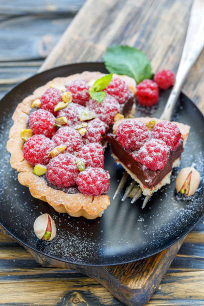 istock Tartlet with raspberries and fork on the plate. 873235932